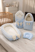 Corrected blue four-piece set with bed nest, wrapper, pillow and fabric baby holder